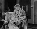 Young woman consoling her friend in wheelchair